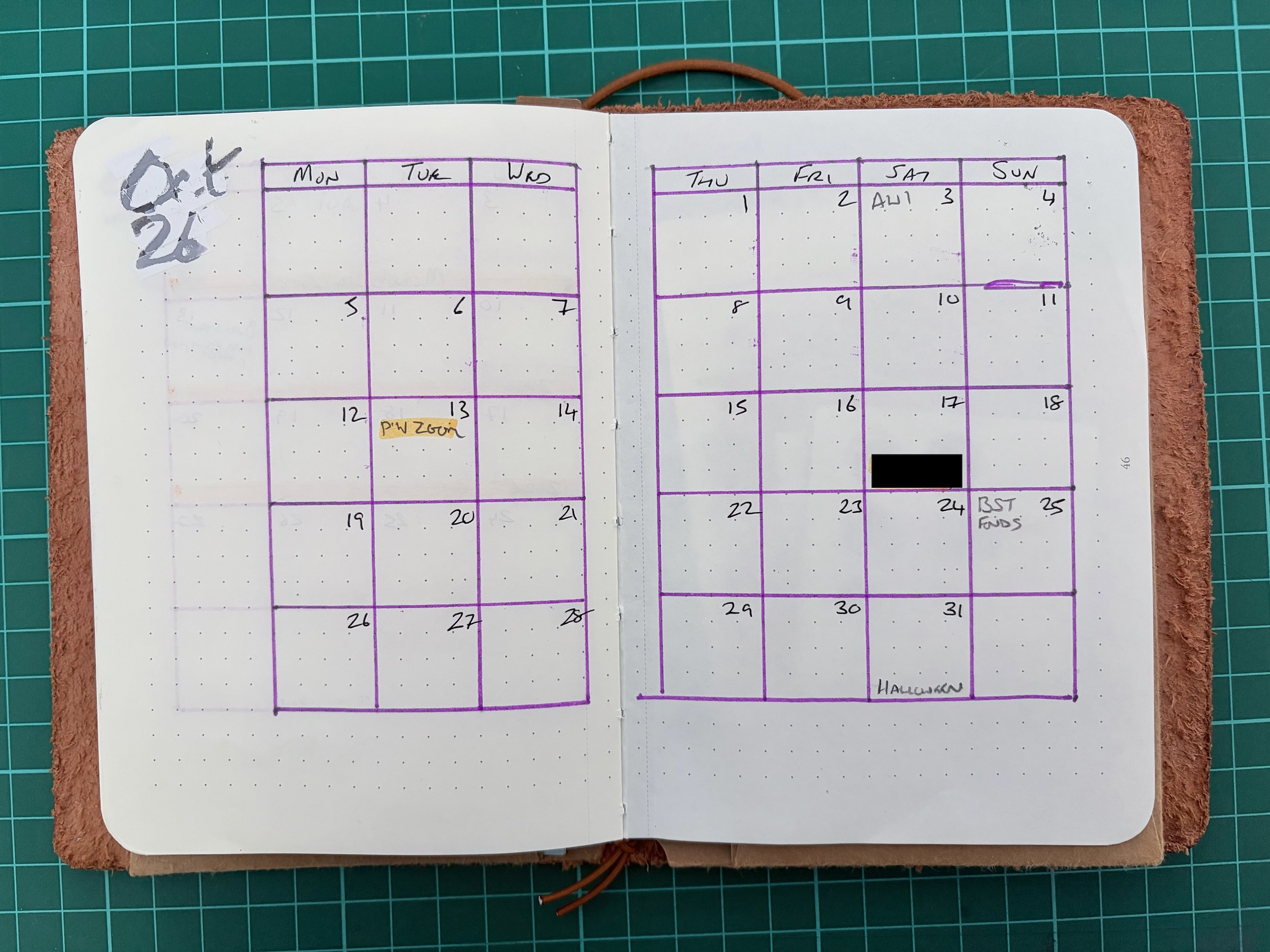 Photo a monthly spread for October 2026 drawn over two pages of an A6 notebook